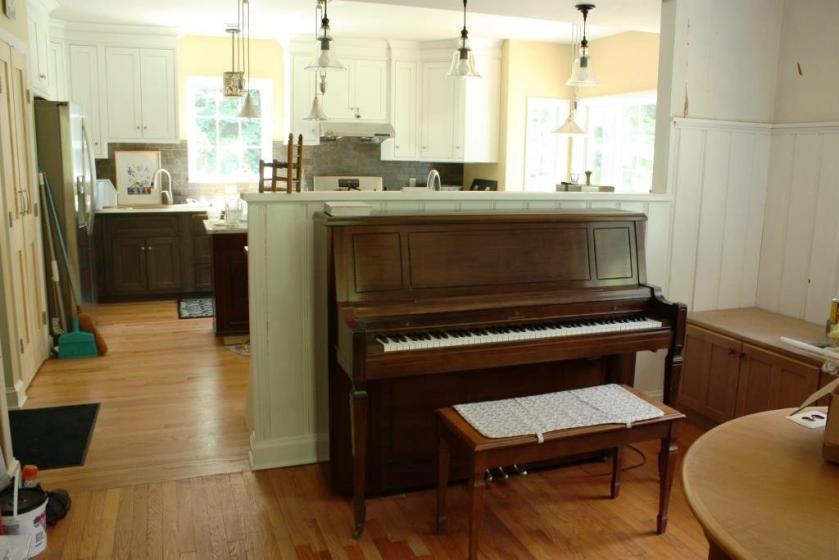 The kitchen is beyond the piano wall and in full daily use.